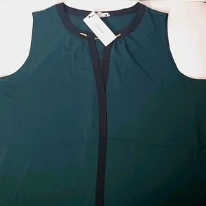 CK Green suit and gold chain detail